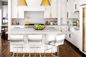 White Kitchen with Marble Countertops and Acrylic Stools