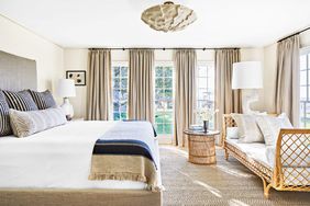 Neutral coastal bedroom with lots of windows