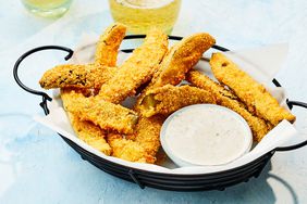 crispy fried pickles in a basket with ranch dipping sauce