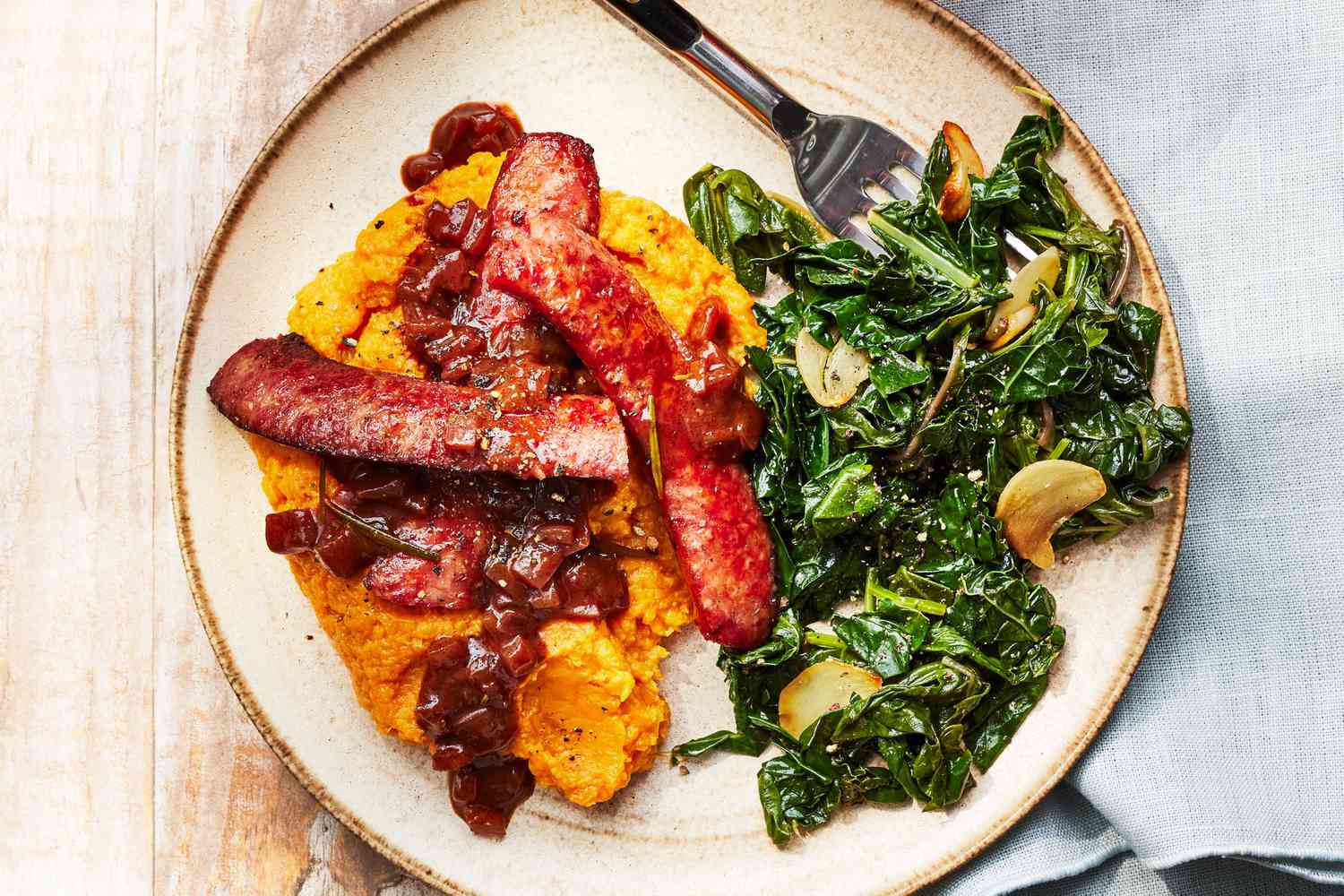 Southern Living Southern Bangers and Mash on a plate with Speedy Sauteed Greens