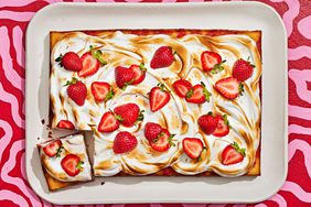 Southern Living Strawberry-Ginger Poke Cake with Toasted Vanilla Meringue on a serving plate