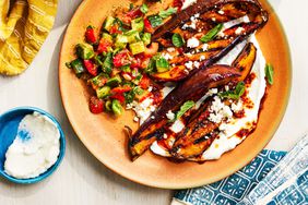 Southern Living Pomegranate Molasses-Glazed Eggplant with Whipped Garlic Sauce on a plate to serve with arabic salad