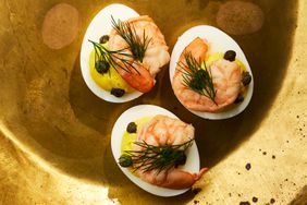 Southern Living Pickled Shrimp Deviled Eggs on a gold surface 