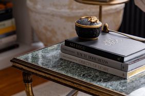 Three books stacked on coffee table