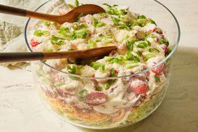 Southern Living 7-Layer Salad in a bowl to serve with serving spoons