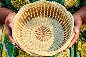 South Carolina Gullah artist Andrea Cayetano Jefferson holds a sweetgrass basket she sewed.