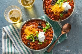 two bowls of chili with two cups of beer