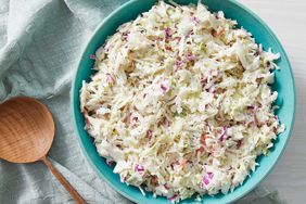 a blue bowl holds buttermilk coleslaw