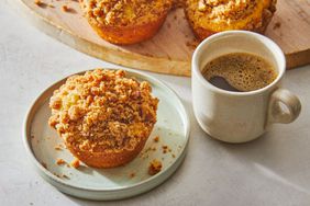 Southern Living Coffee Cake Muffins on a plate with a cup of coffee to serve