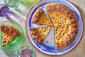 Southern Living Cookie Cake on a platter to serve with a couple of slices cut