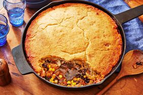 Southern Living Cornbread Cowboy Casserole in the skillet with a serving scooped out