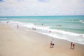 Emerald Isle, North Carolina - people walking on beach and swimming in ocean