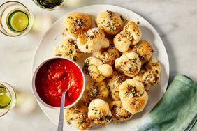 Southern Living Garlic Knots ready to serve with pizza sauce for dipping