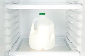 a gallon of milk in an empty fridge