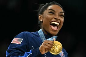 US' Simone Biles poses with the gold medal during the podium ceremony for the artistic gymnastics women's team final during the Paris 2024 Olympic Games