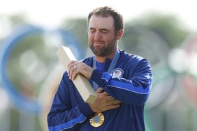 Gold medalist, Scottie Scheffler of Team United States reacts on the podium during the Men's Individual Stroke Play medal ceremony following Day Four of the Men's Individual Stroke Play on day nine of the Olympic Games Paris 2024 at Le Golf National on August 04, 2024 in Paris, France. 