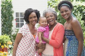 Multi-generation women smiling in backyard