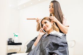 Woman on Phone at Hair Salon