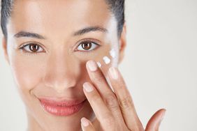 Woman Putting on Face Cream