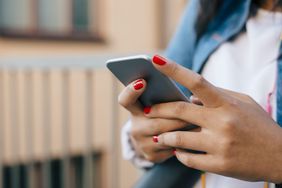 Cropped image of teenage girl using mobile phone