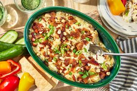 Southern Living Hot Bacon and Swiss Dip scooped out and ready to serve with vegetables 