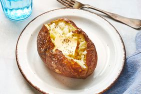 Southern Living Microwave Baked Potato on a plate to serve with a pat of butter on top