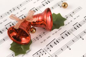 Red Jingle Bells over Sheet Music