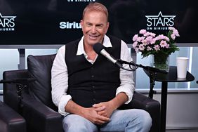 Kevin Costner Smiling, Seated in front of microphone