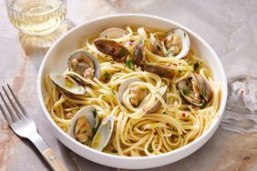 Linguine with Clams in a bowl to serve with a glass of white wine