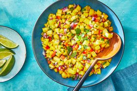 Southern Living Mango Salsa in a bowl with a wooden spoon