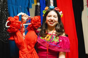 Sofiia Medrano holds up a donated dress