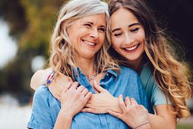 Adult Daughter Hugs Mom with Long Hair