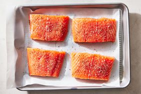 Southern Living Pan Seared Salmon seasoning the fish before cooking