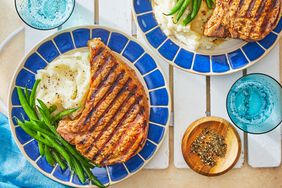 Southern Living Grilled Pork Chops on plates to serve with green beans and mashed potatoes