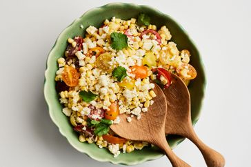 Southern Living Corn-and-Tomato Salad in a serving bowl with salad servers