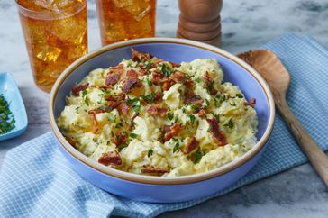 Southern Living Southern Style Potato Salad in a bowl to serve with two glasses of sweet tea behind