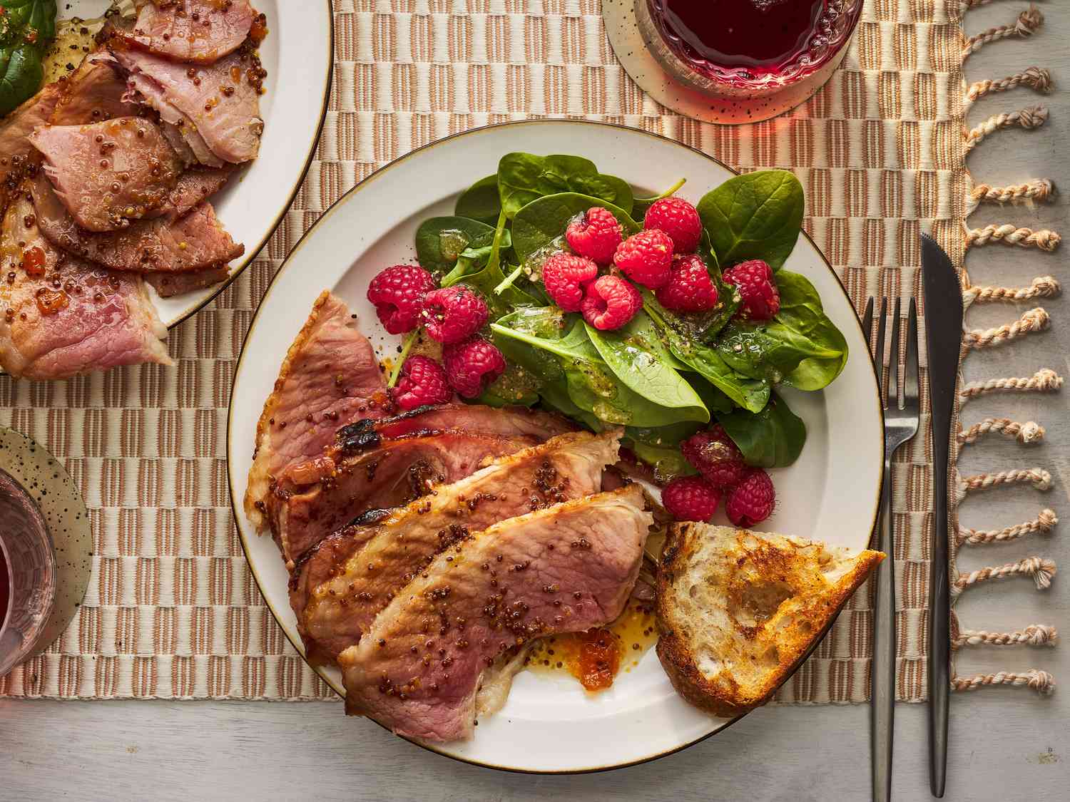 Southern Living Slow Cooker Ham two servings on two plates with salad and bread