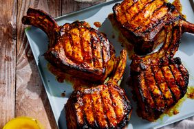 Pork Chops with Carolina Barbecue Sauce, Smoked Butter, and Braised Onions on a platter to serve