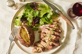 Southern Living Steak Diane on a plate to serve with a baked potato and salad