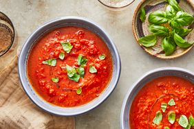 Southern Living Tomato Soup in bowls topped with basil and olive oil