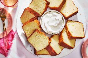 Southern Living Whipped Cream Cake sliced and ready to serve with whipped cream