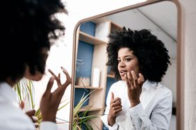 Young woman applying lip care